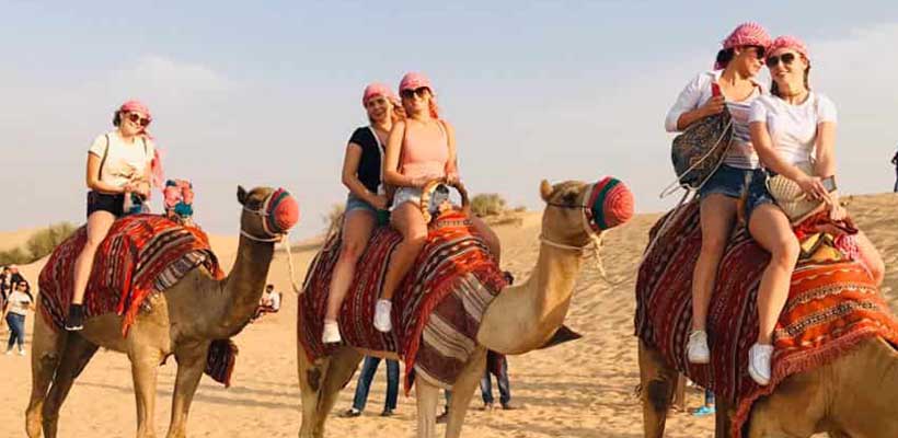 Tourist doing Camel Ride during Dubai Desert Safari