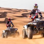 Tourist Riding Quad Bike in Dubai Desert