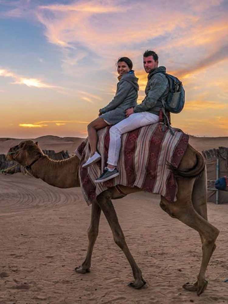 Tourist Riding Camel in Dubai Desert Safari