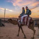 Couple Riding Camel together during Evening Safari in Dubai