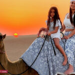 Tourist Woman & her Baby Girl enjoying Camel Ride