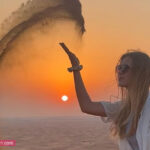 Tourist Girl Photo during Sunset in Dubai Desert
