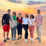 Tourist Group Photo during Sunset in Dubai Desert