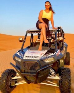 Tourist Girl Sitting on top pf Dune Buggy for Photoshot