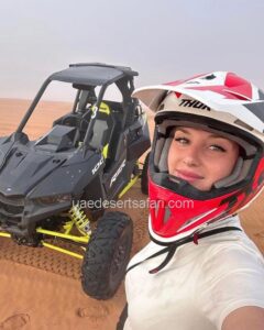 Tourist Girl Wearing Helmet standing in front of Dune Buggy