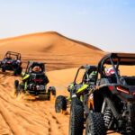 Multiple Tourists Riding Dune Buggies in an Arabian Desert