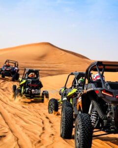 Multiple Tourists Riding Dune Buggies in an Arabian Desert