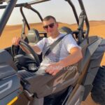 Tourist Man Riding Dune Buggy in Dubai Desert