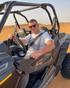 Tourist Man Riding Dune Buggy in Dubai Desert