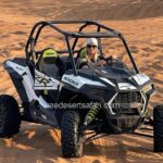 Tourist Girl Riding Dune Buggy in Arabian Desert