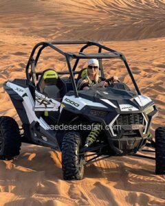 Tourist Girl Riding Dune Buggy in Arabian Desert