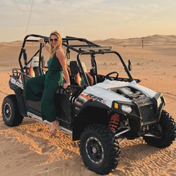 Tourist Girl Standing on 4-seater Dune Buggy Ride Dubai
