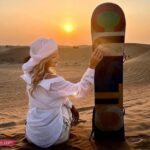 Girl with Sand Board vip desert safari tour