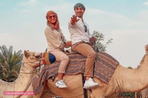 Camel Riding Tourist Couple Desert Safari Dubai Tour
