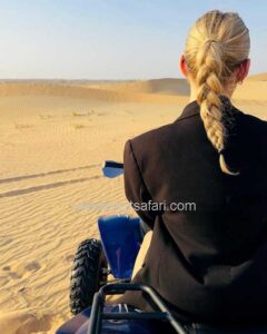 Tourist Girl back view on Quad Bike Ride Dubai