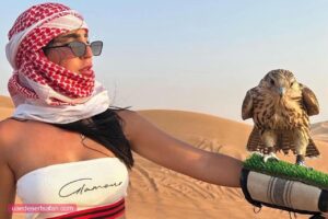 Tourist Holding Falcon Desert Safari Tour