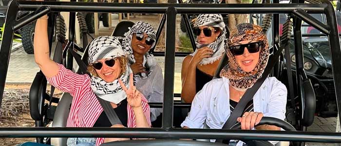 Dubai Desert Safari Blog - Group of Tourist Women in Dune Buggy - Dubai Travel & Tourism